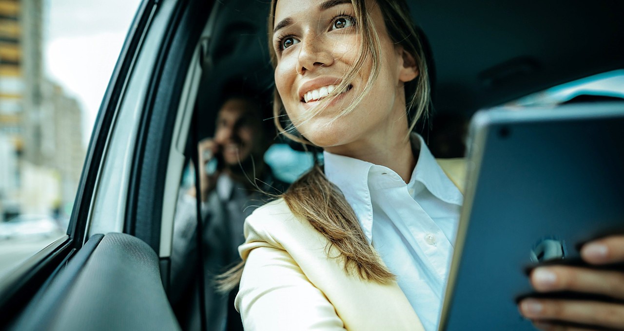 Woman sitting in car smiling