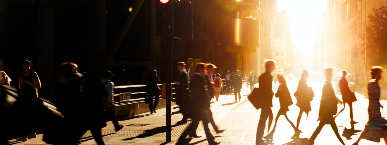 Sunset view of people walking in a city