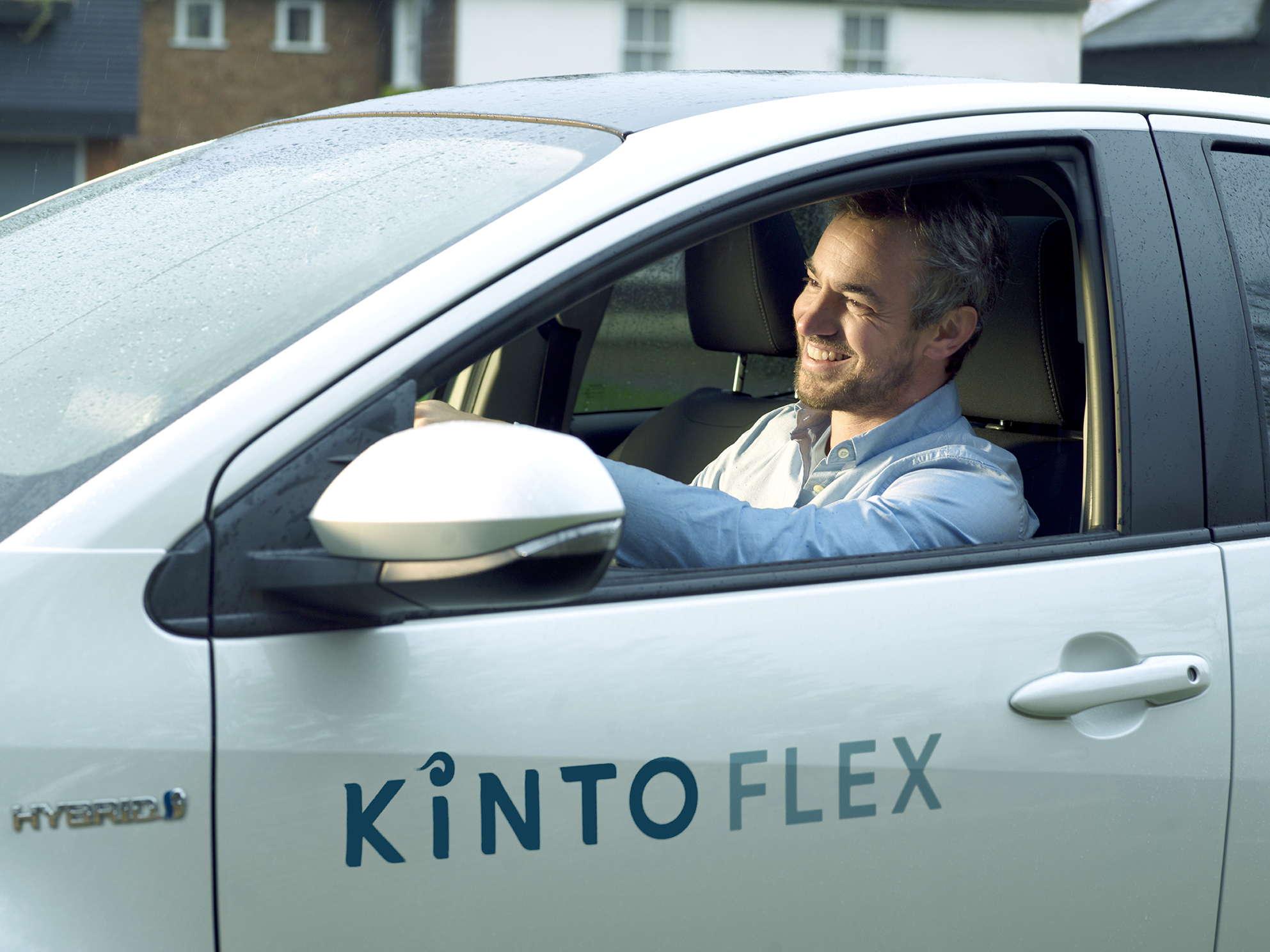 Man driving in a KINTO Flex car subscription vehicle