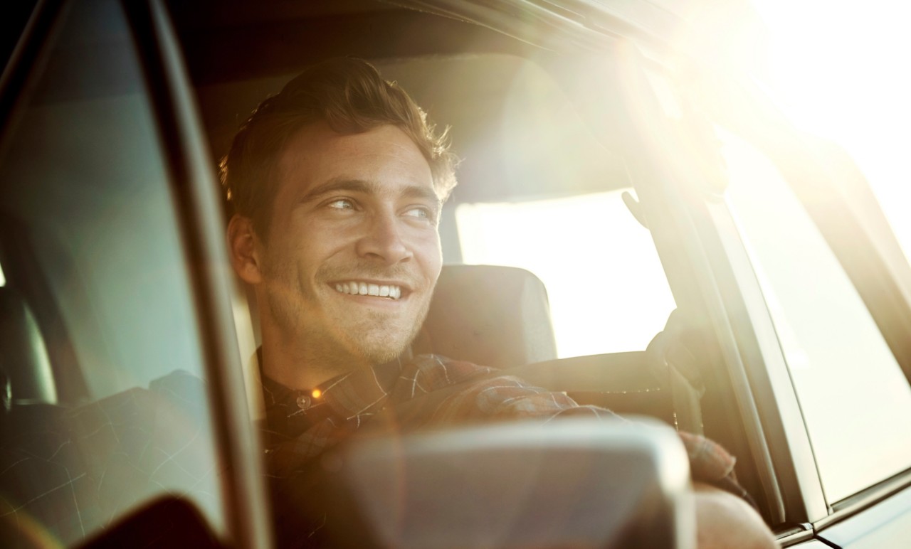 Man smiling out of car window